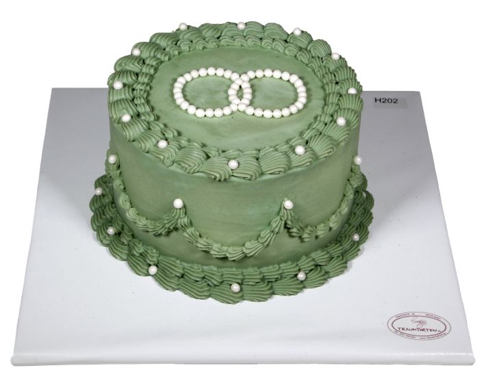 Grüne Hochzeitstorte mit gespritzten Verzierungen