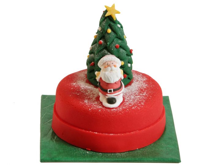 Weihnachtsmann vor Tannenbaum-Torte