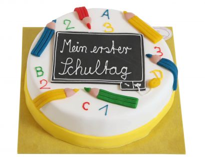 Bunte Einschulungstorte mit Tafel und Stiften