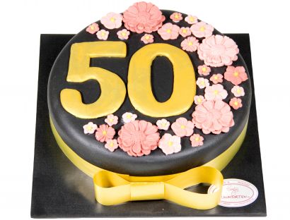 Elegante Festtagstorte mit Gold- und Blütendekor